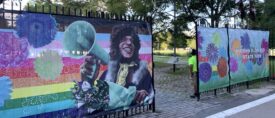 Photo of gates with images on them of Marsha P. Johnson