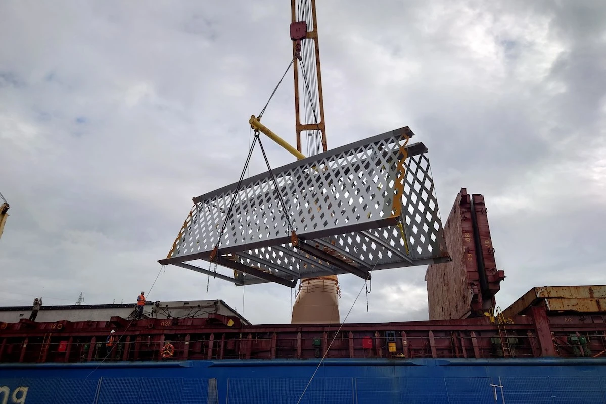 bridge components being lifted into a ship.