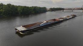 A bridge being transported by barge